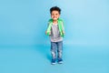 Full length body size view of handsome cheerful boy going to primary academic school isolated over bright blue color Royalty Free Stock Photo