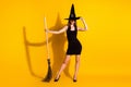 Full length body size view of her she nice attractive pretty slender thin creepy spooky lady wizard standing with broom