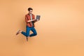 Full length body size view of his he nice attractive cheerful cheery successful brunet guy jumping in air using laptop Royalty Free Stock Photo