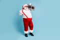 Full length body size view of his he nice bearded cheerful cheery positive glad Santa carrying tape cassette player Royalty Free Stock Photo