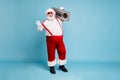 Full length body size view of his he nice cool bearded fat cheerful cheery Santa carrying retro vintage cassette player Royalty Free Stock Photo