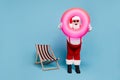 Full length body size view of his he nice cool comic glad cheerful cheery fat Santa carrying pink swimming circle having