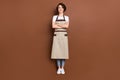 Full length body size view of lovely cheerful glad girl store shop seller folded arms isolated over brown color