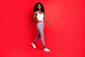 Full length body size view of lovely cheerful thin content girl going isolated over bright red color background