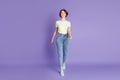 Full length body size view of lovely thin cheerful proud girl going straight isolated over violet color background