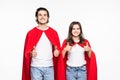 Full length body size view of man and woman in red hero look hugging showing thumbup isolated on white background