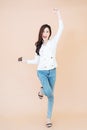 Full length body size view of nice attractive cheerful young girl jumping listening music pop audio mp3 in earbuds, holding Royalty Free Stock Photo