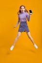 Full length body size view of nice cheerful cheery woman in headhones jumping Royalty Free Stock Photo