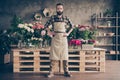 Full length body size view portrait of his he nice attractive content guy wearing uniform among peony different bunch Royalty Free Stock Photo