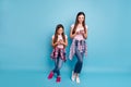 Full length body size view portrait of two nice charming attractive cheerful cheery straight-haired girls using internet Royalty Free Stock Photo