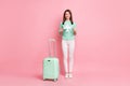 Full length body size view of pretty cheery girl traveler holding in hand paper plane safe arrival isolated on pink Royalty Free Stock Photo