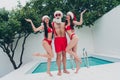 Full length body size view of three beautiful handsome cheerful group Santa having fun hugging vacation poolside relax