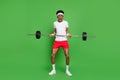 Full length body size view of trendy tired weak guy nerd sportsman lifting heavy barbell isolated over bright green