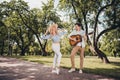 Full length body size view of two attractive glad cheerful couple playing guitar dancing having fun rest pastime on Royalty Free Stock Photo