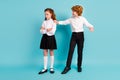 Full length body size view of two nice kids guy supporting offended girl isolated over bright blue color background