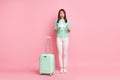 Full length body size view of worried girl traveler holding in hand paper plane flight phobia isolated on pink color Royalty Free Stock Photo