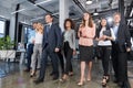 Full Length Business People Team Walking In Modern Office, Confident Businessmen And Businesswomen In Suits Diverse With