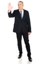 Full length businessman touching abstract screen