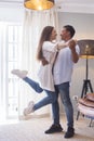 .Full length of carefree young couple dancing at home together Royalty Free Stock Photo