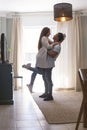 .Full length of carefree young couple dancing at home together Royalty Free Stock Photo