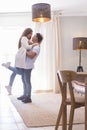 .Full length of carefree young couple dancing at home together Royalty Free Stock Photo