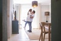 .Full length of carefree young couple dancing at home together Royalty Free Stock Photo