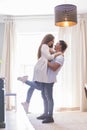 .Full length of carefree young couple dancing at home together Royalty Free Stock Photo