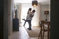 .Full length of carefree young couple dancing at home together Royalty Free Stock Photo