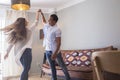 .Full length of carefree young couple dancing at home together Royalty Free Stock Photo