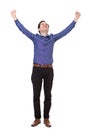 Full length carefree young man standing with arms outstretched in joy Royalty Free Stock Photo