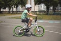 Caucasian child boy, athletic cyclist, wearing active wear and safety sports helmet riding bike outdoor. Sport concept