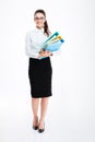 Full length of cheerful young businesswoman standing and holding folders Royalty Free Stock Photo