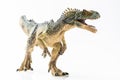 Full length close up image of an Allosaurus plastic figurine on white background