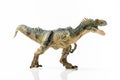 Full length close up image of an Allosaurus plastic figurine on white background