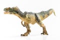 Full length close up image of an Allosaurus plastic figurine on white background
