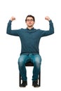 Full length confident businessman seated on chair, flexes muscles imagine superpower, isolated on white. Business person, looking