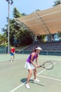 Confident female tennis player waiting to hit the ball during do Royalty Free Stock Photo