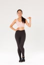Full length of confident smiling asian female athelte in sportsbra and leggigns, fitness girl pointing at herself, lead