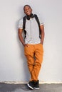 Full length cool young african american man standing against gray wall Royalty Free Stock Photo