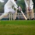 Full length of cricketer playing on field during sunny day, Cricketer on the field in action, Players playing cricket match at fie