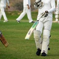 Full length of cricketer playing on field during sunny day, Cricketer on the field in action, Players playing cricket match at fie