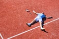 Full length of disappointed mature man lying by tennis racket on court during summer Royalty Free Stock Photo