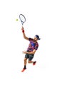 Full-length dynamic image of young man, tennis player in bright sportswear in motioned during game, hitting ball