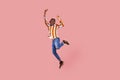 Full length excited ecstatic afro-american man with dreadlocks in striped shirt highly jumping and posing, showing victory gesture Royalty Free Stock Photo