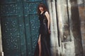 Full-length fashion model in black dress posing in the street ne Royalty Free Stock Photo