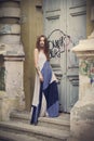 Full length fashion portrait modern woman standing near old door Royalty Free Stock Photo