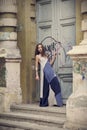 Full length fashion portrait modern woman standing near old door Royalty Free Stock Photo