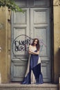 Full length fashion portrait modern woman standing near old door Royalty Free Stock Photo