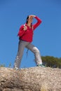Full length female hiker standing over the cliff and looking away Royalty Free Stock Photo