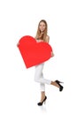 Full length girl holding up a red cardboard heart, ioslated on w Royalty Free Stock Photo